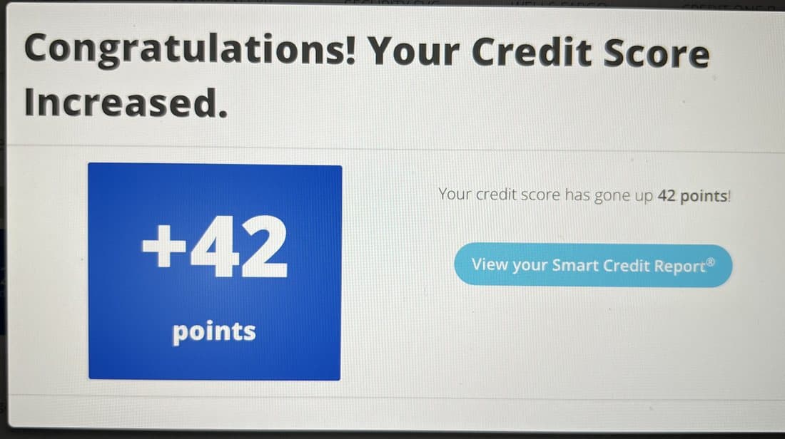 SmartCredit popup reading your credit score has gone up 42 points.